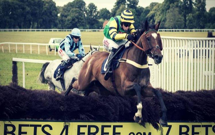 Two runners jumping a fence at Worcester Racecourse