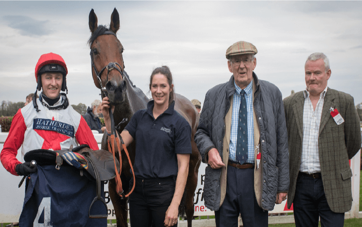 A winning race team pose for a photograph