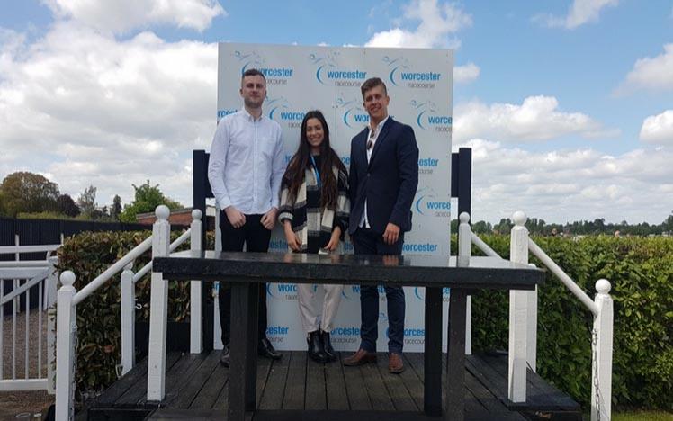 Students pose for a photo at Worcester Racecourse