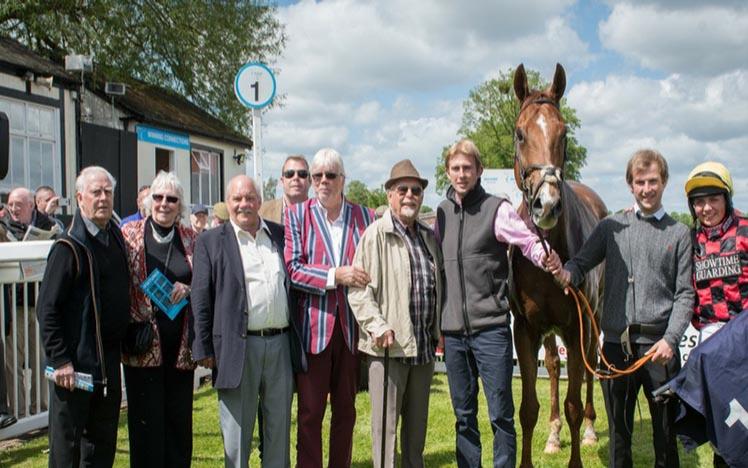 A winning team pose for the traditional photograph at Worcester Racecourse