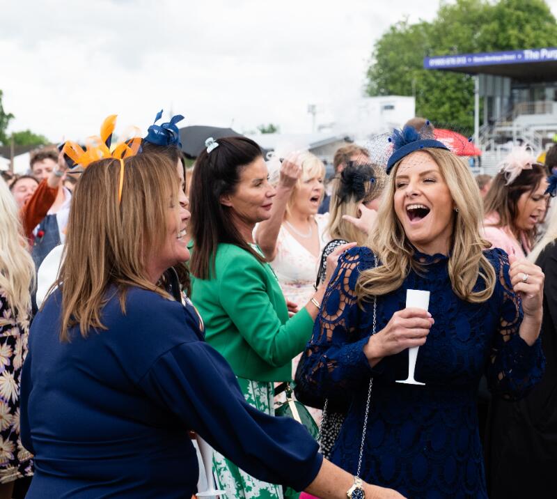 Race goers singing to entertainment at Worcester Races