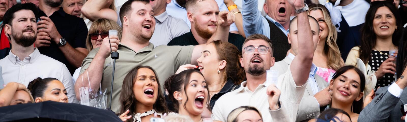 A close up of cheering racegoers at Worcester Racecourse