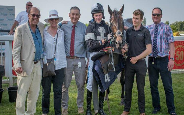 A winning team pose for a photographa t Worcester Racecourse