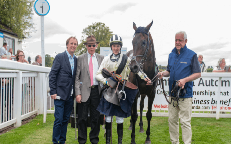 An image of a race winning team at Worcester Racecourse