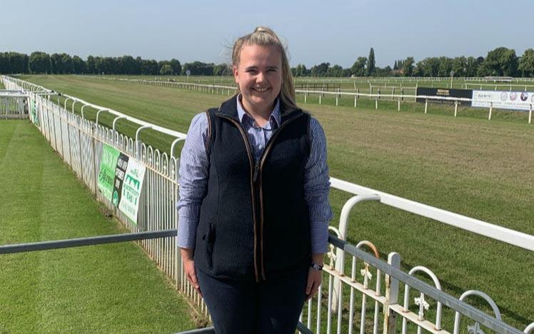 A lady poses for the camera at Worcester Racecourse