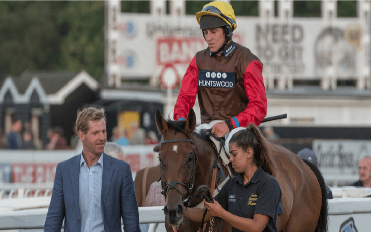 A winning team head towards the winners enclosure at Worcester Racecourse