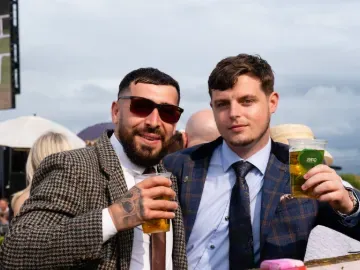 Two race goers at Worcester in suits pose for the camera