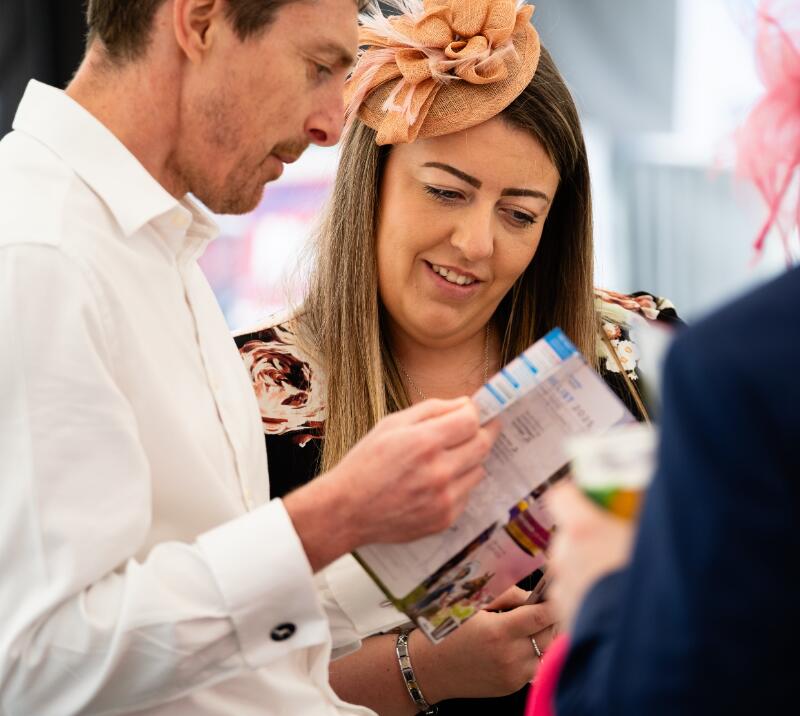 A couple study the race card at Worcester Races