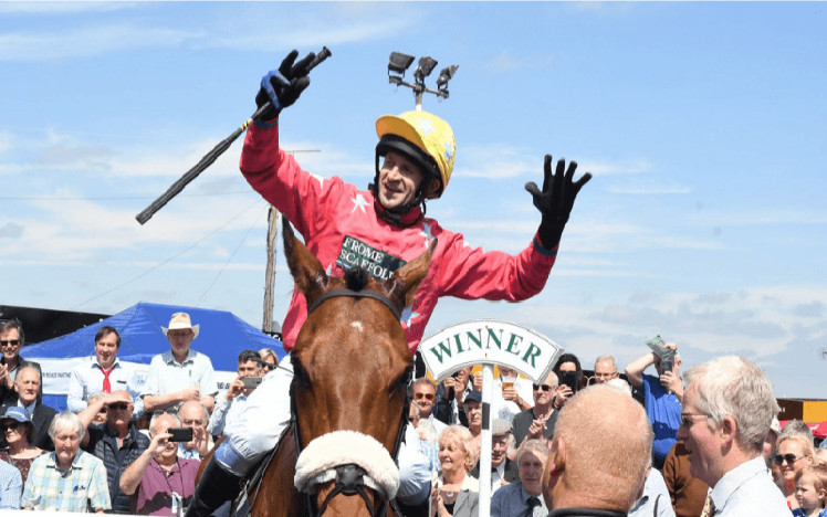 A picture of Gold Cup Winning Jockey Andrew Thornton mounted on a horse.