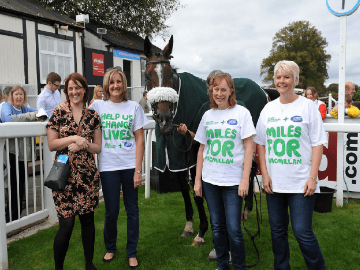 Ladies from Macmillan Cancer Support pose with a Racehorse promoting Worcester Racecourses 5th Annual Macmillan Raceday