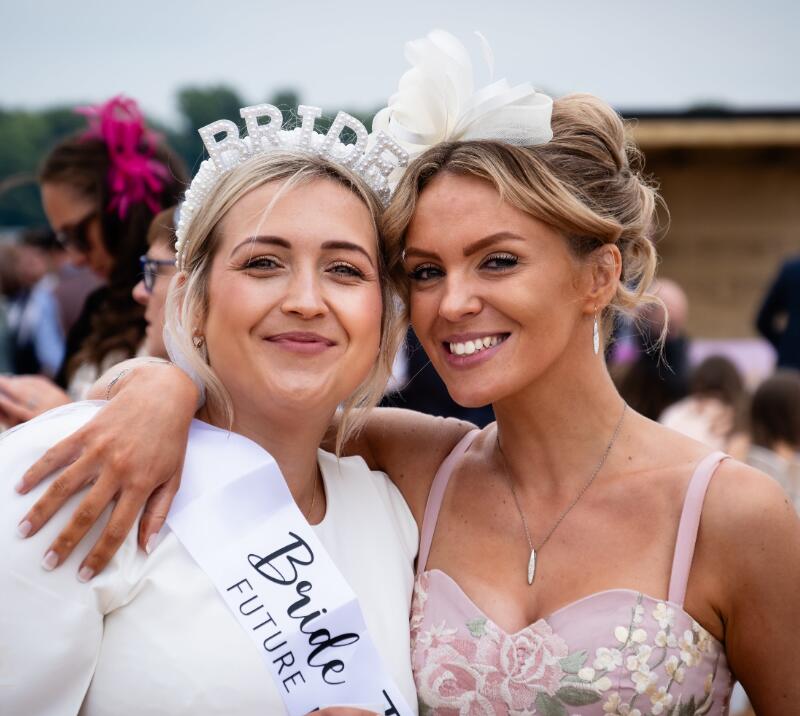 A bride to be posing with a member of her hen party at Worcester Races.