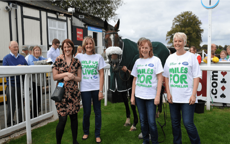 Ladies from Macmillan Cancer Support pose with a Racehorse promoting Worcester Racecourses 5th Annual Macmillan Raceday