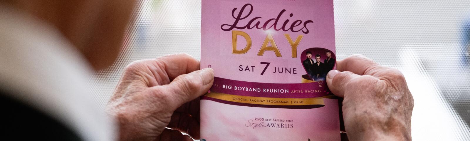 A close up of the front of a race card held by a gentleman attending Worcester Races